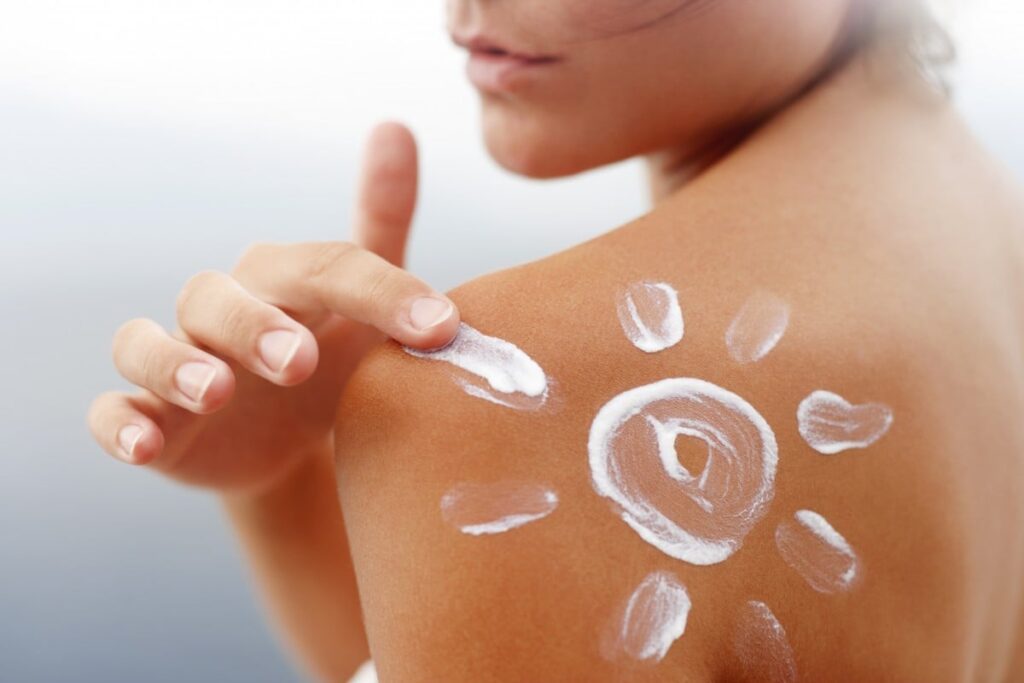 Women Putting On Sunscreen