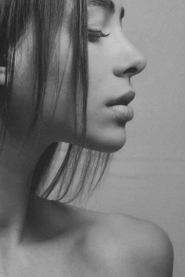 Profile of a woman with smooth skin and refined facial features.