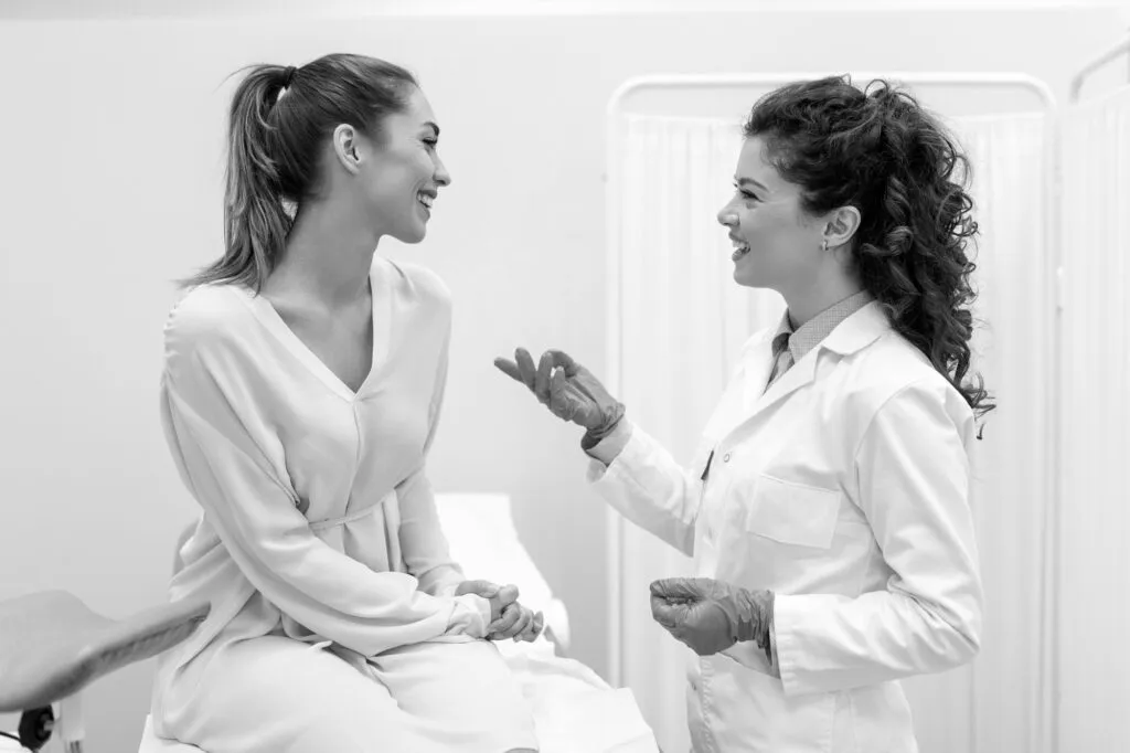 Doctor consulting with a patient in a plastic surgery clinic.