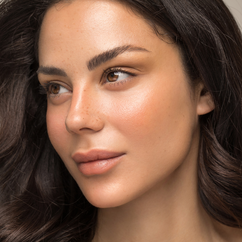 Facial treatment with sheet mask applied by professional at a plastic surgery center.