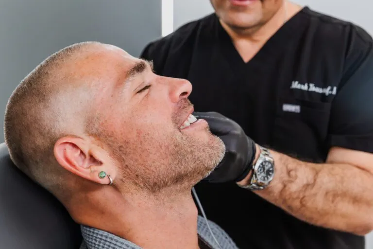 Man receiving consultation at a plastic surgery center.