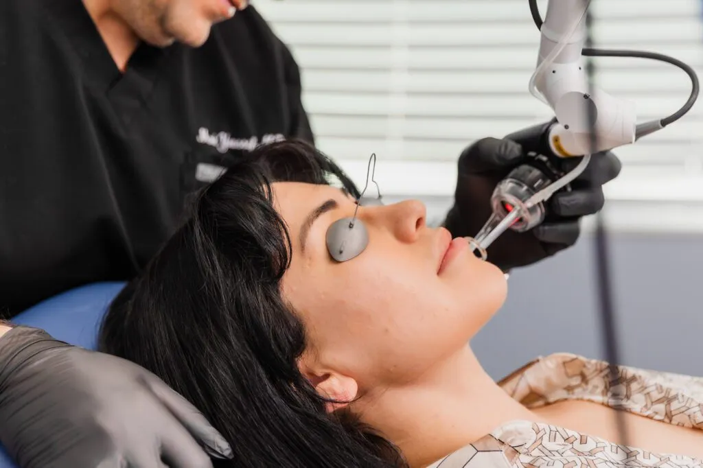 Patient receiving laser treatment at plastic surgery center.