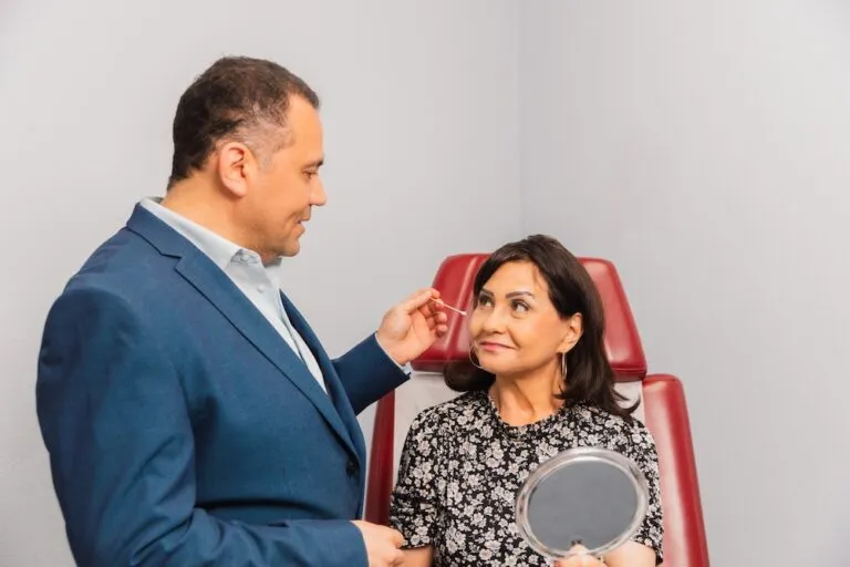 Plastic surgeon consulting with a woman in a clinic.