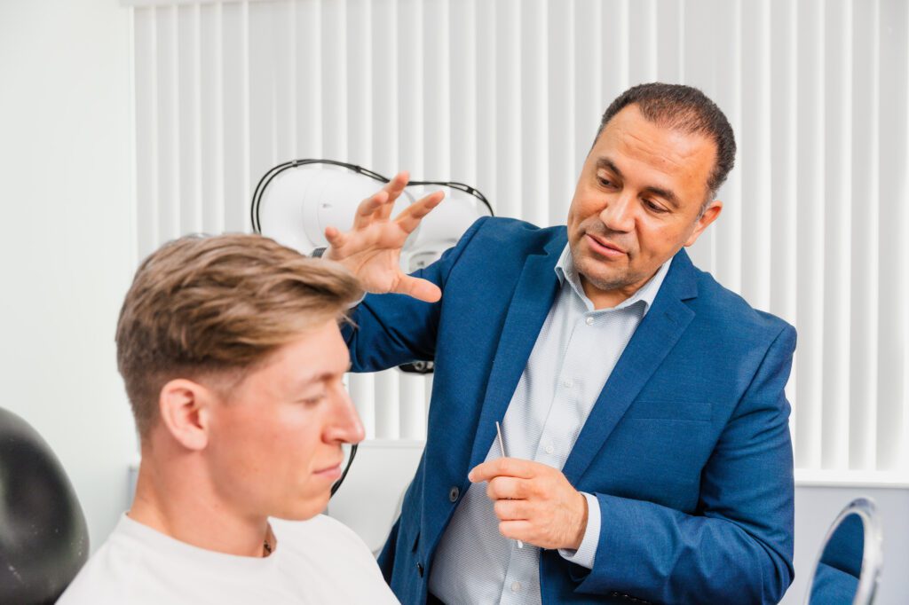 Plastic surgeon consulting with a patient in a clinic office.