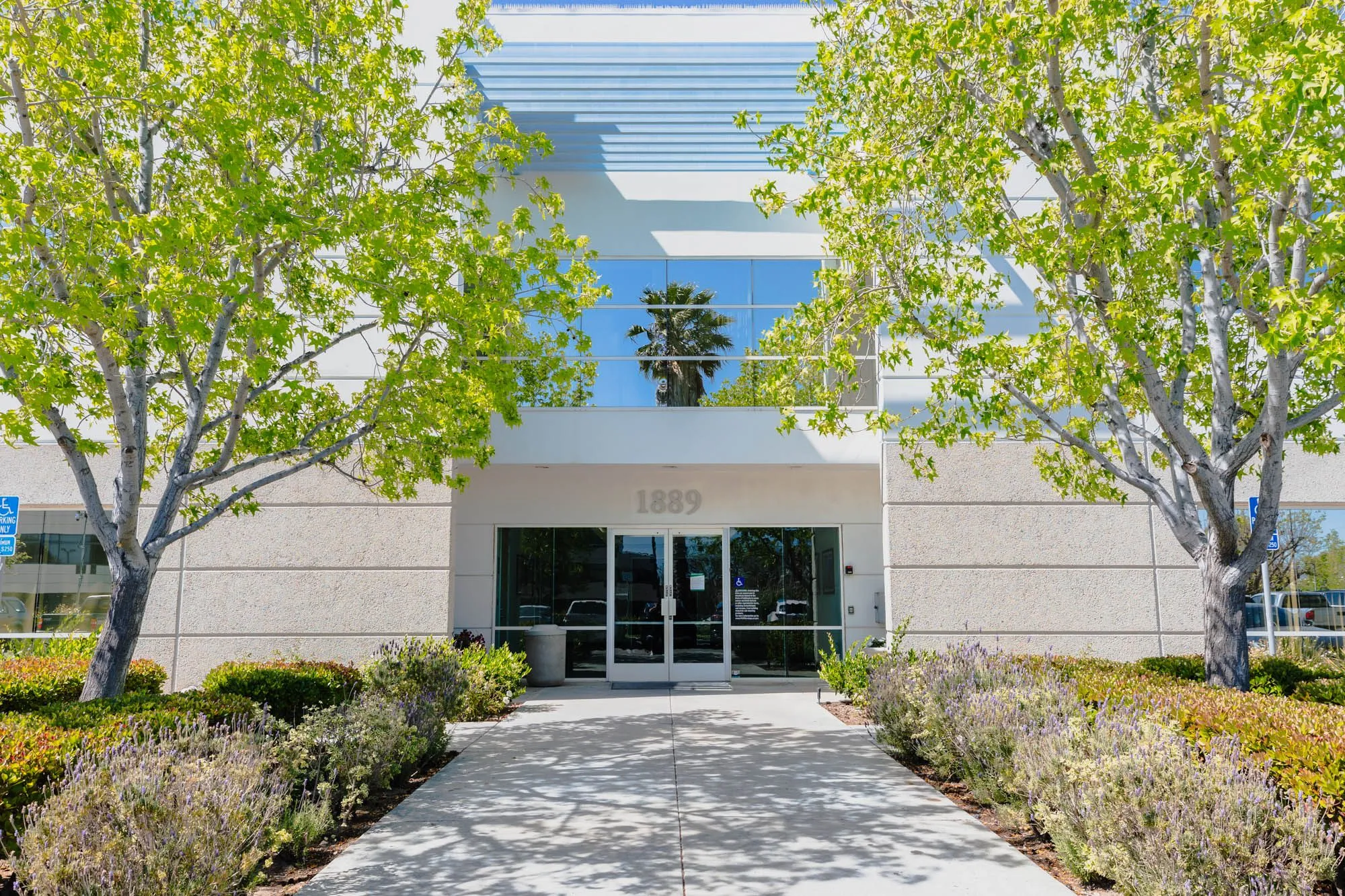 MEDSPA in OXNARD CA - picture of the modern exterior of the plastic surgery center with trees and shrubs.