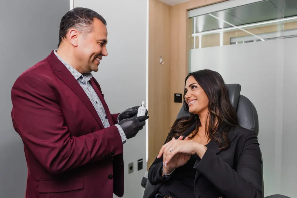 Doctor discussing treatment options with a patient at a plastic surgery center.