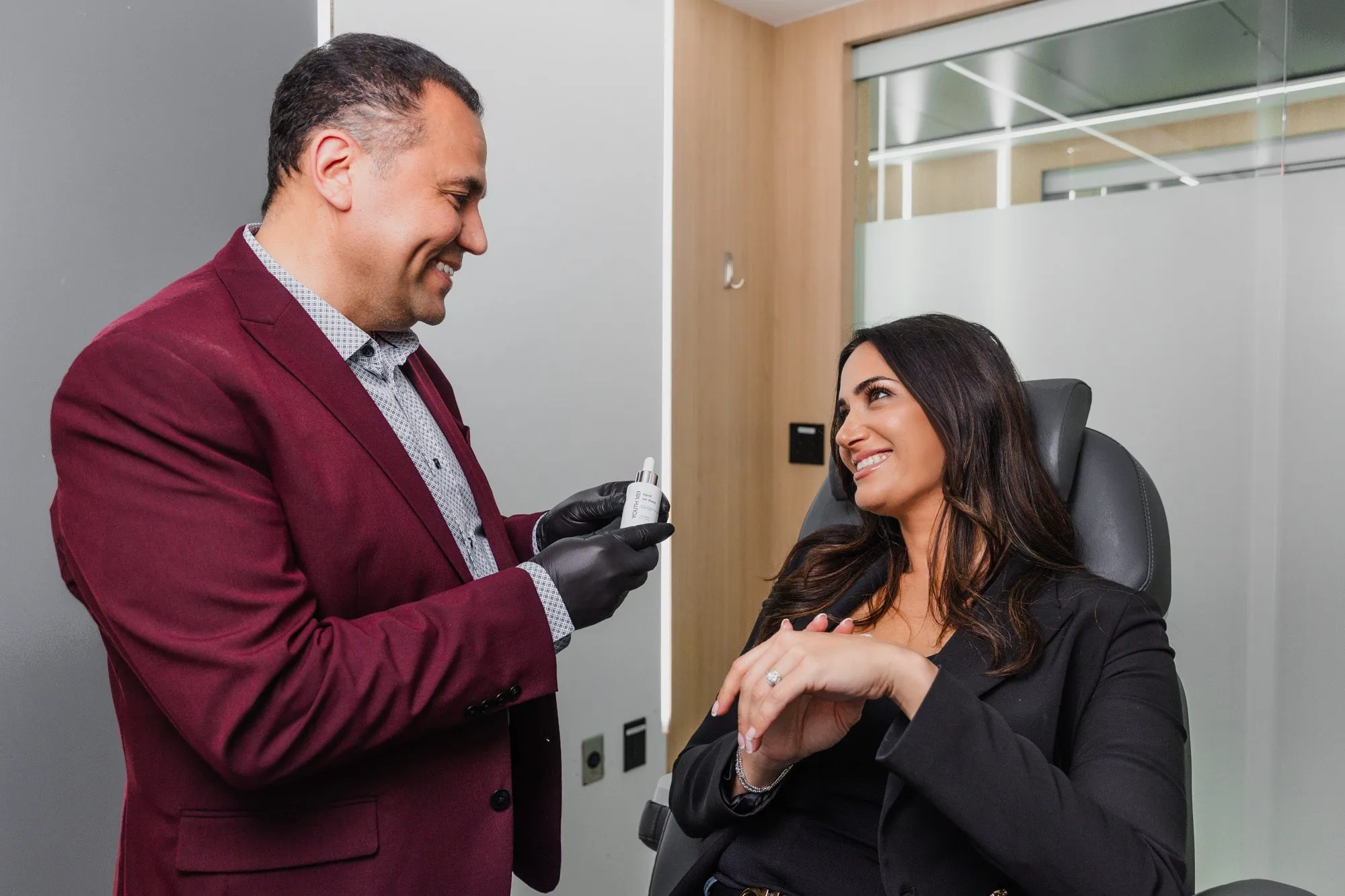 Doctor discussing treatment options with a patient at a plastic surgery center.