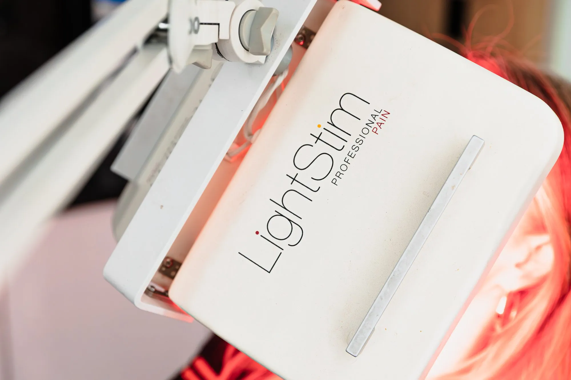 LightStim professional LED therapy device in use at a plastic surgery center.