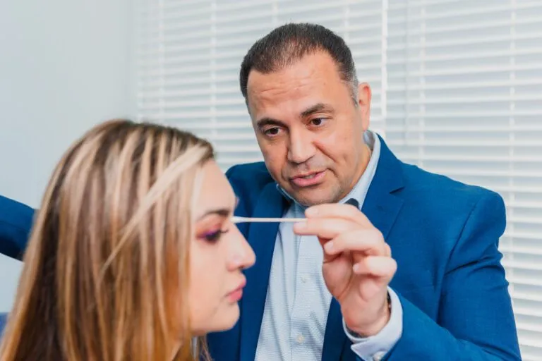 Plastic surgeon consulting with a patient about rhinoplasty options.