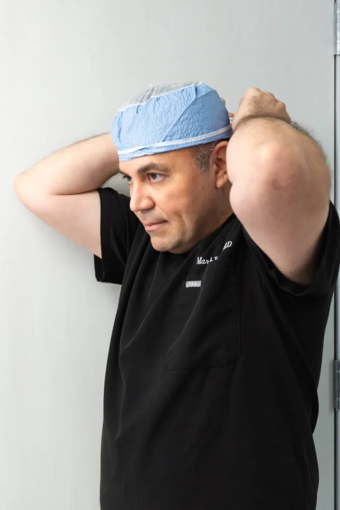 Plastic surgeon preparing for surgery at a plastic surgery center.