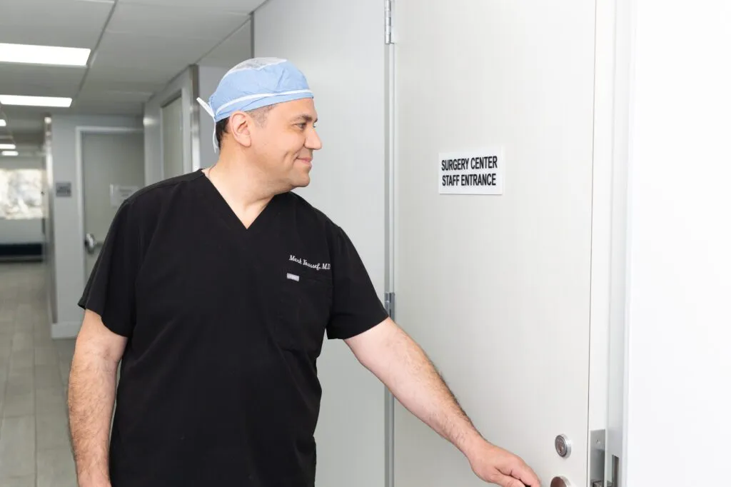 Surgeon entering plastic surgery center staff entrance.