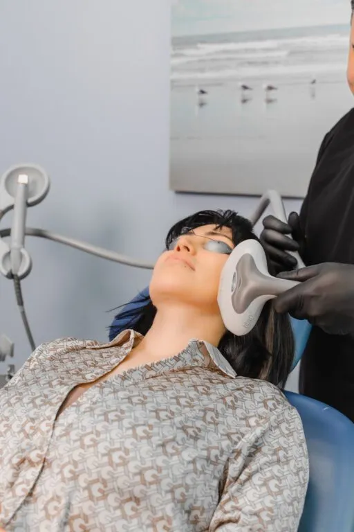 Person receiving non-surgical facial treatment at a plastic surgery center.