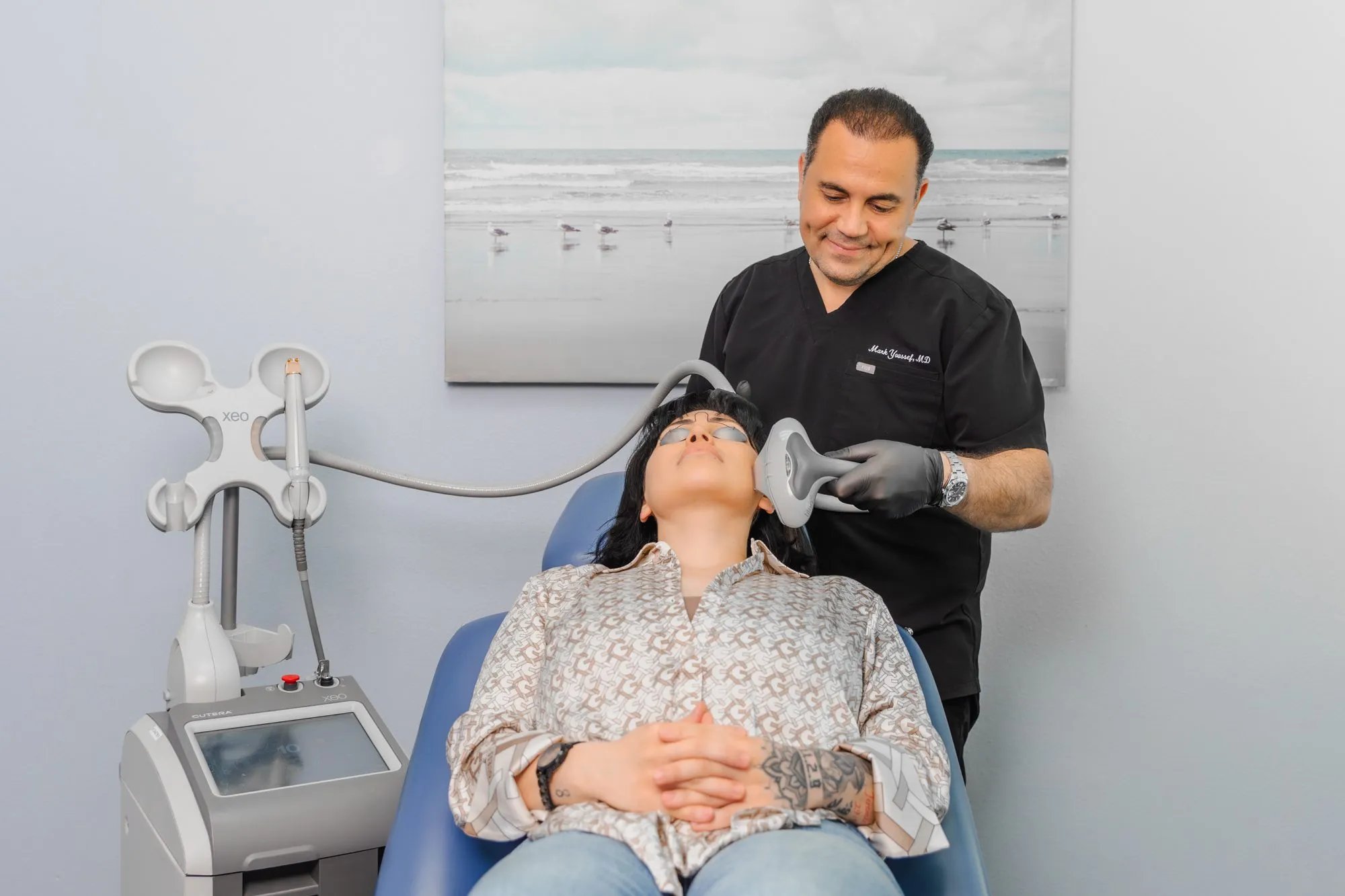 Doctor performing a non-surgical facial treatment on a patient in a plastic surgery center.