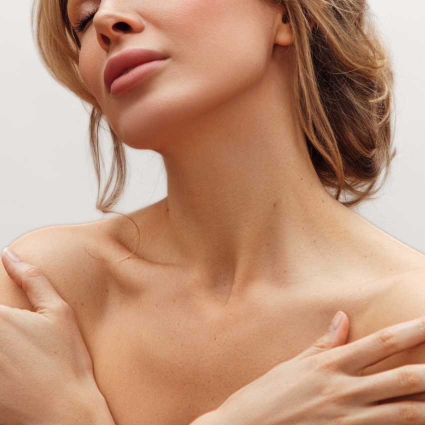 Two women sitting and talking in a modern, comfortable setting at a plastic surgery consultation.