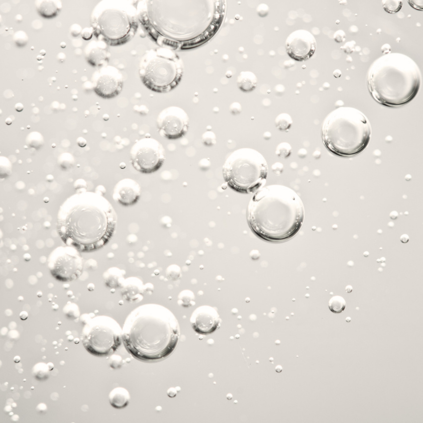 Person relaxing with headphones on, highlighting tranquility and comfort at a plastic surgery center.